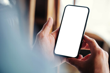 cell phone blank white screen mockup.hand holding texting using mobile on desk at office.background empty space for advertise.work people contact marketing business,technology