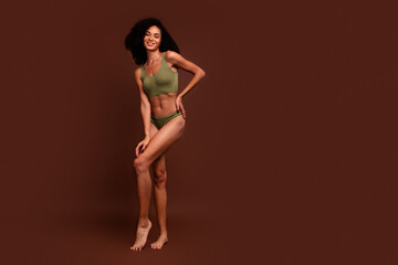 No retouch full length photo of charming girl strong muscular athletic body empty space isolated on brown color background