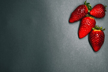 ripe strawberry berries on a dark background. space for your text