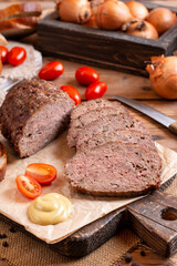 Traditional baked meatloaf slices on wooden table. Sekana Pecene - Czech Meatloaf