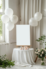 Minimalist party or wedding decor setup with white balloons tied to a chair, a blank canvas on an easel, and a bouquet of roses on a draped table