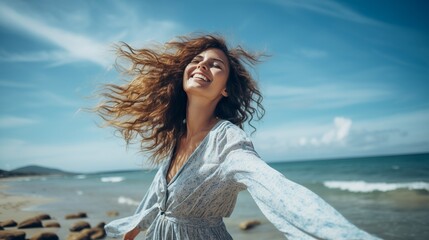 Capture a beautiful portrait of a young woman at the beach with arms wide open, relishing in free time and the liberating feeling of freedom outdoors. 