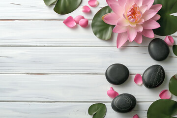 Zen spa concept with lotus flower and massage stones on white wooden background. Flat lay composition with copy-space, perfect for wellness, meditation, and relaxation themes