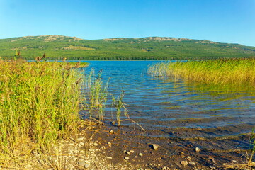 Alpine lake talkas against the backdrop of the Irendyk ridge of the Southern Urals in the Republic of Bashkortostan