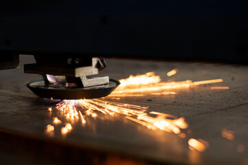 close-up laser cutting of metal on a CNC machine, at a large machine-tool plant in the center of the country