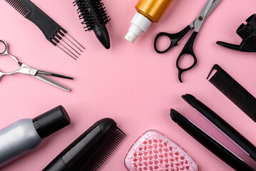 Hairdresser tools on pink background.