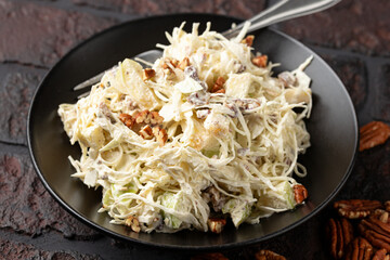 sweet cabbage raisins and pecan nuts salad with creme fraiche