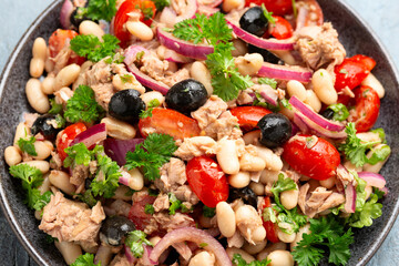 White cannellini bean tuna salad with olive, red onion, tomatoes. Healthy food