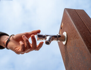hand about to press the tap