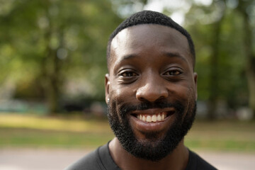 Close-up of smiling man standing in park