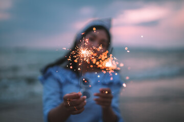 girl holding a sparkler in her hand