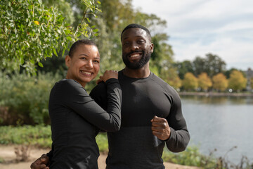 Portrait of smiling athletic couple in park