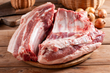 Raw fresh pork belly on wooden board. Traditional Czech dish