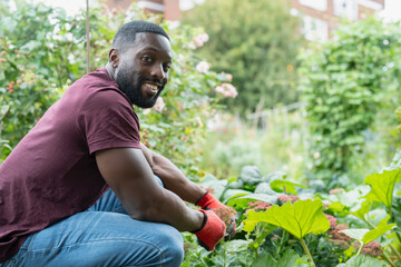 Portrait of smiling man working in urban garden