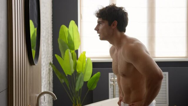 Millennial naked Caucasian man looking at mirror male check hair style baldness dandruff hairstyle hairdo mask care shampoo cosmetics morning beauty routine procedure guy pointing finger reflection