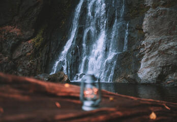 The lantern on the log behind is the waterfall.