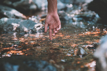 A hand that is kicking the clear water