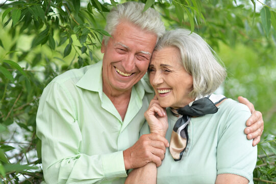 Beautiful senior couple posing and hugging in the park