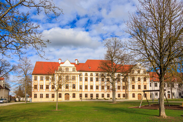 Fototapeta na wymiar The Benedictine Abbey of Thierhaupten in Bavaria on a spring day with a blue sky and changing cloud cover
