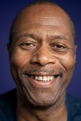 Portrait of smiling man against purple background