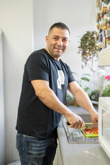 Portrait of man preparing food in kitchen