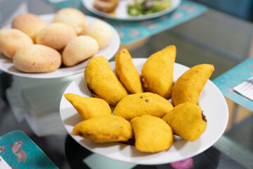 Plate of fresh empanadas on dining table