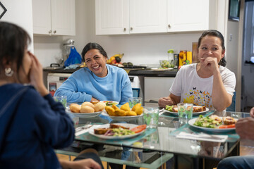 Family sitting at dining table and enjoying lunch