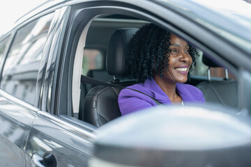 Smiling woman driving car