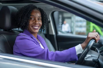 Fotobehang Portrait of smiling woman driving car © Cultura Creative
