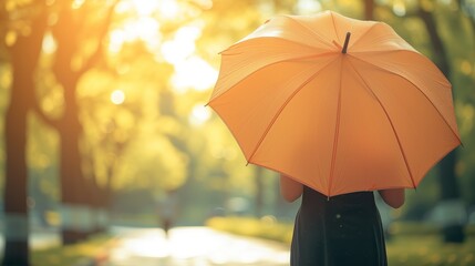 Woman holding yellow umbrella,sunny day