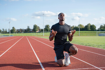Athlete preparing to sprint at running track