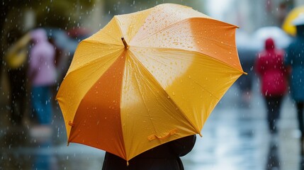 Rear view of woman holding yellow umbrella, rainy