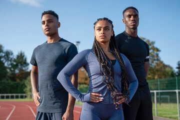 Portrait of group of athletes standing at stadium