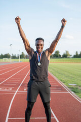 Portrait of athlete celebrating with medal