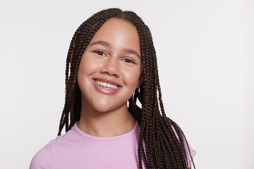 Studio portrait of smiling girl with braided hair