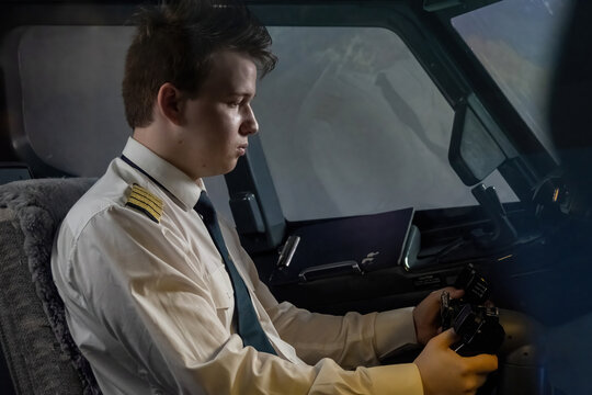 Pilot skillfully navigates airplane with helm at night. Young captain ensures smooth and uneventful flight for all on board