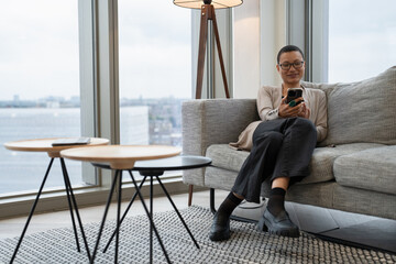 Non binary person resting in office lobby