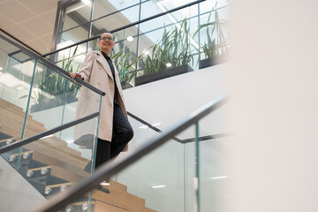 Non binary office worker walking on steps