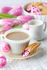 A vintage cup and saucer with tea, served with French Madeleines.