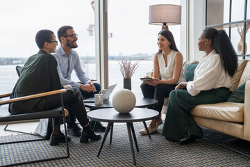Business people having meeting in office lobby