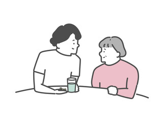 高齢女性の服薬介助を行う女性介護士