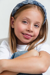 Close-up of funny kid girl happy positive smile show grimace tongue-out on white
