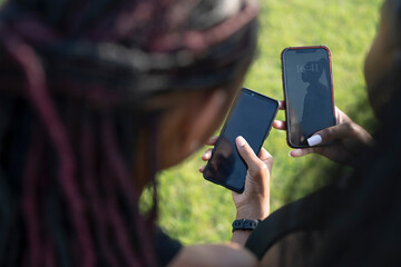 Close-up of female friends holding smart phones