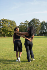 Young female friends walking in park after exercising