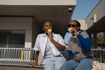 Young female friends eating ice cream