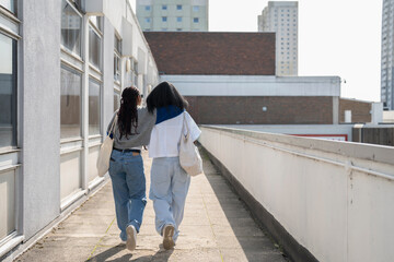 Young female couple walking in city