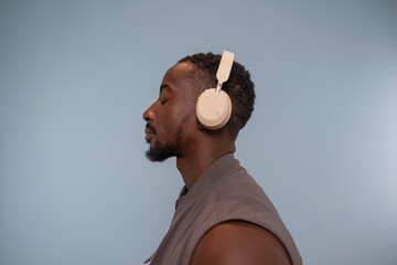 Profile of man wearing headphones and listening to music