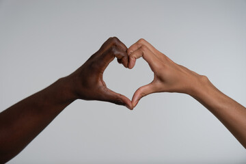 Couple shaping heart with hands