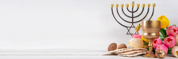 Passover celebration background. Traditional ritual Jewish bread matzah, red kosher wine, walnut,...