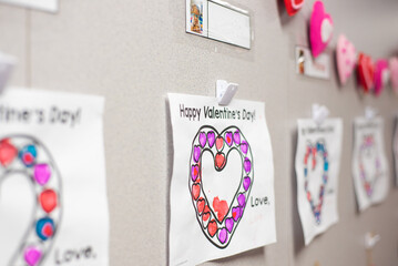 Happy Valentine Day message with handcrafted heart shape pinned attached classroom wall for...